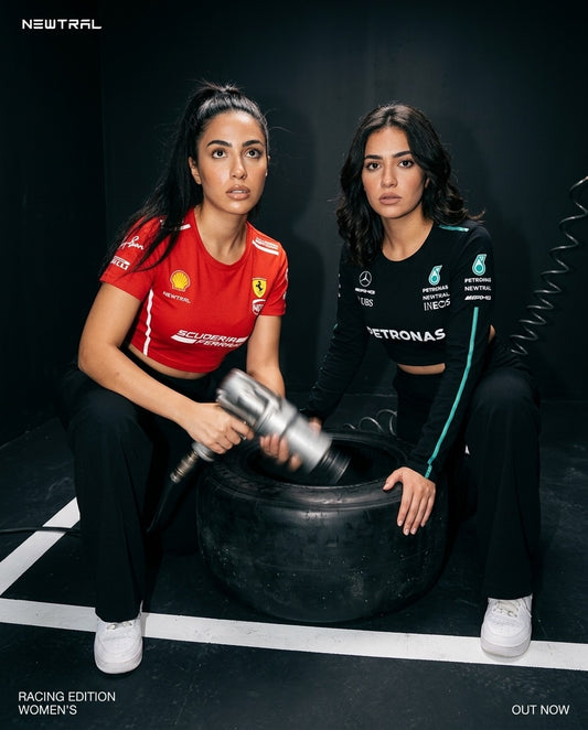 Ferrari Scuderia Women's Crop Tee (Red) and Mercedes-AMG Petronas Women's Longsleeve Crop (Black) bundle: Same crouching-wheel concept, alternate generation, slightly different crop/expression