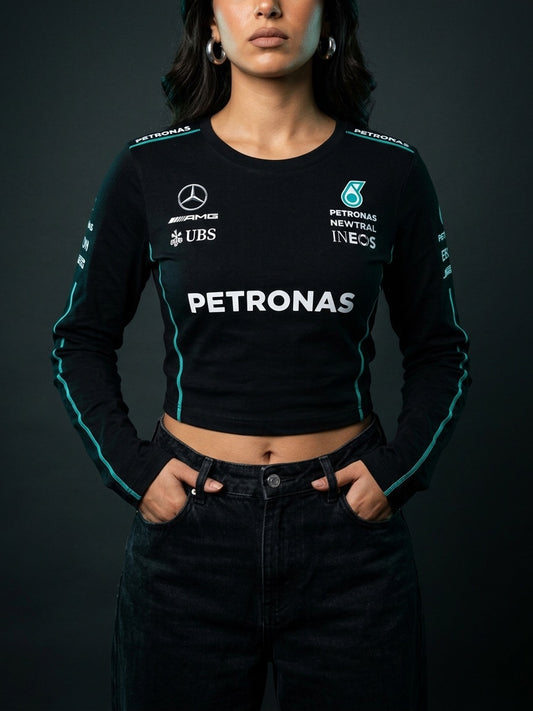 Newtral Mercedes-AMG Petronas women's long-sleeve crop top in black, front view close, hands in pockets, studio